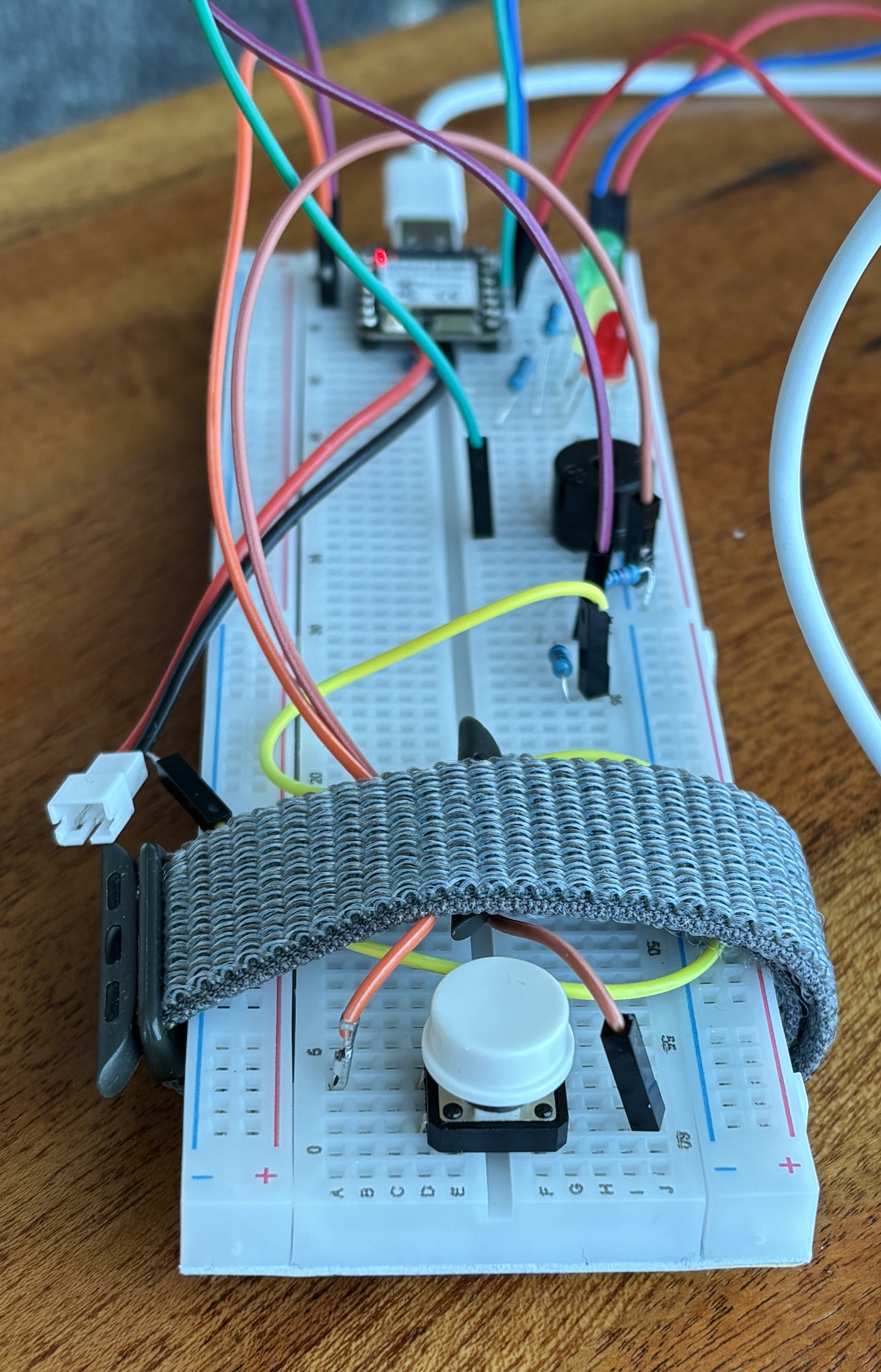 Frankenbutton prototype with breadboard, button ring, and battery strap